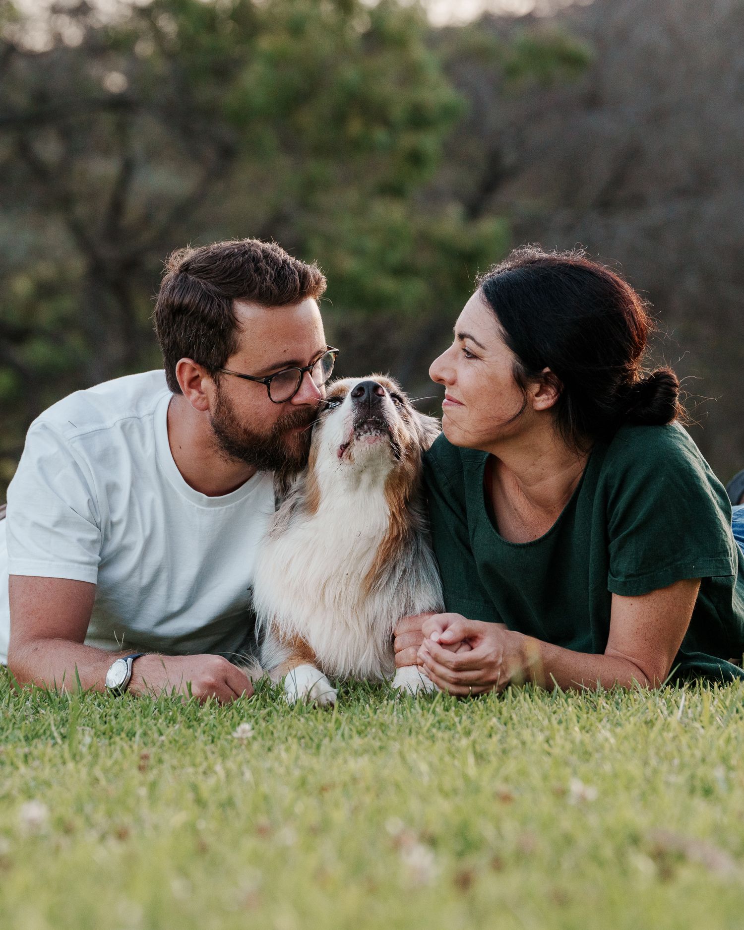 couple and their dog laying down during a photoshoot in sydney