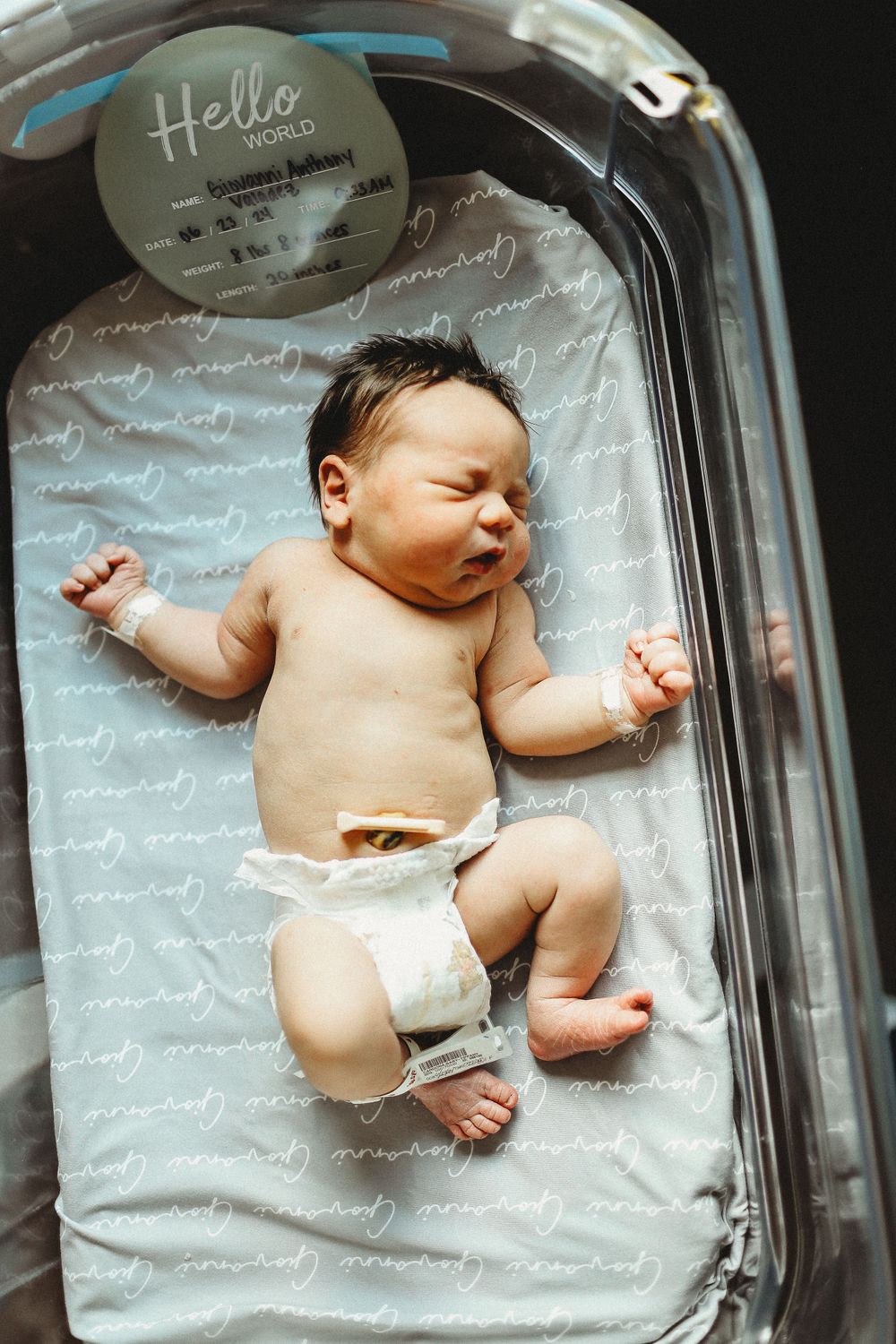 Baby boy stretched out in hospital bed for fresh 48 session