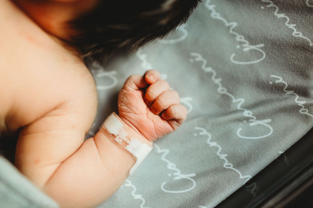 Newborn baby boy hand for fresh 48 session