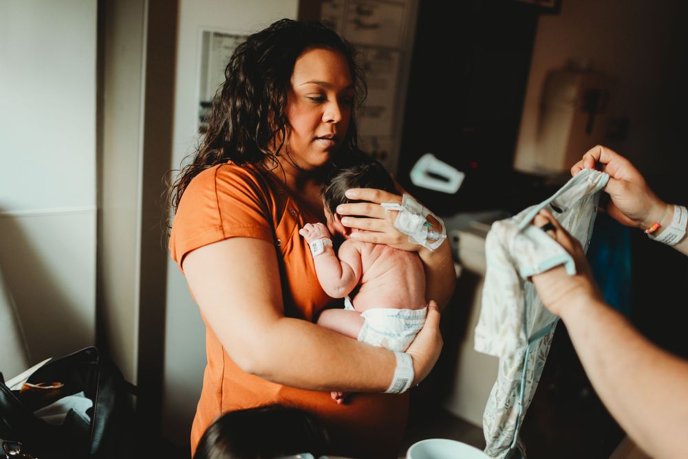 Mom holding baby on chest for fresh 48 session