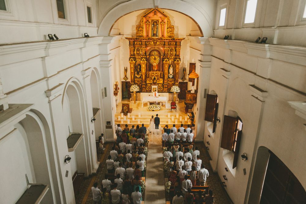 Inside of a church where a wedding ceremony is taking place.