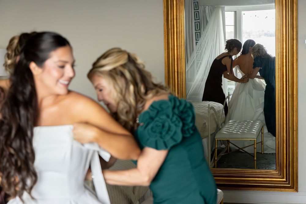 A sequence of wedding preparation photos showing moments of getting ready in a sunlit room with mirrors and gold frames.