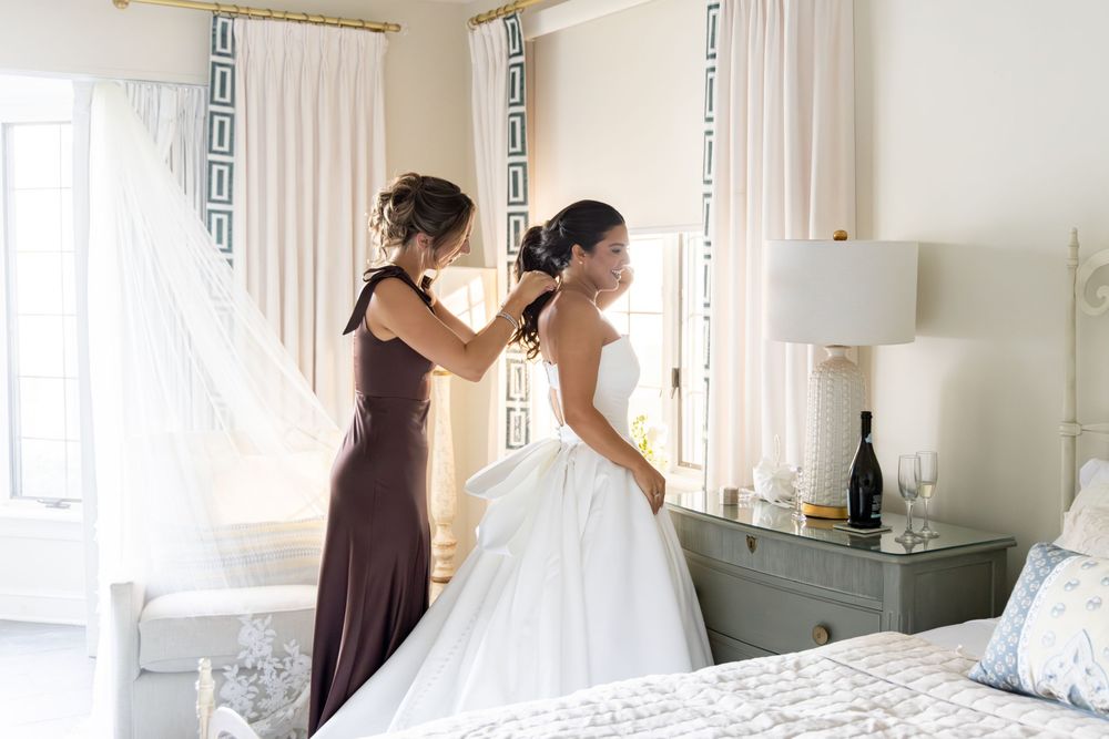 A series of wedding preparation photos showing a bride getting ready in a bright hotel room with white decor.
