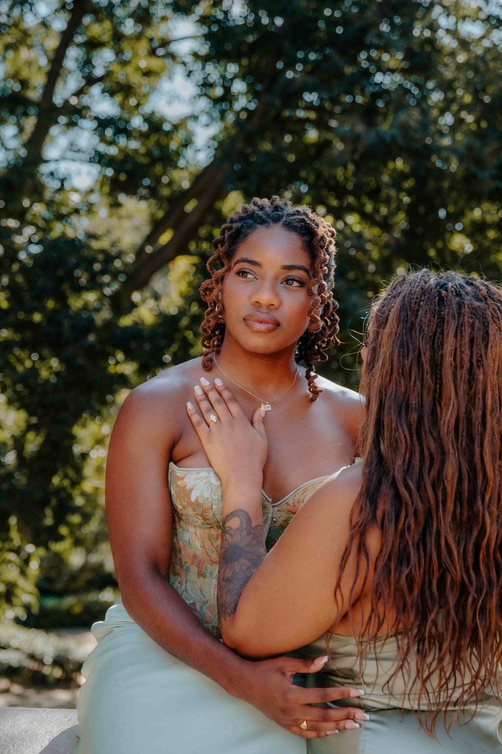 Joyful laughter and connection between newly engaged women.