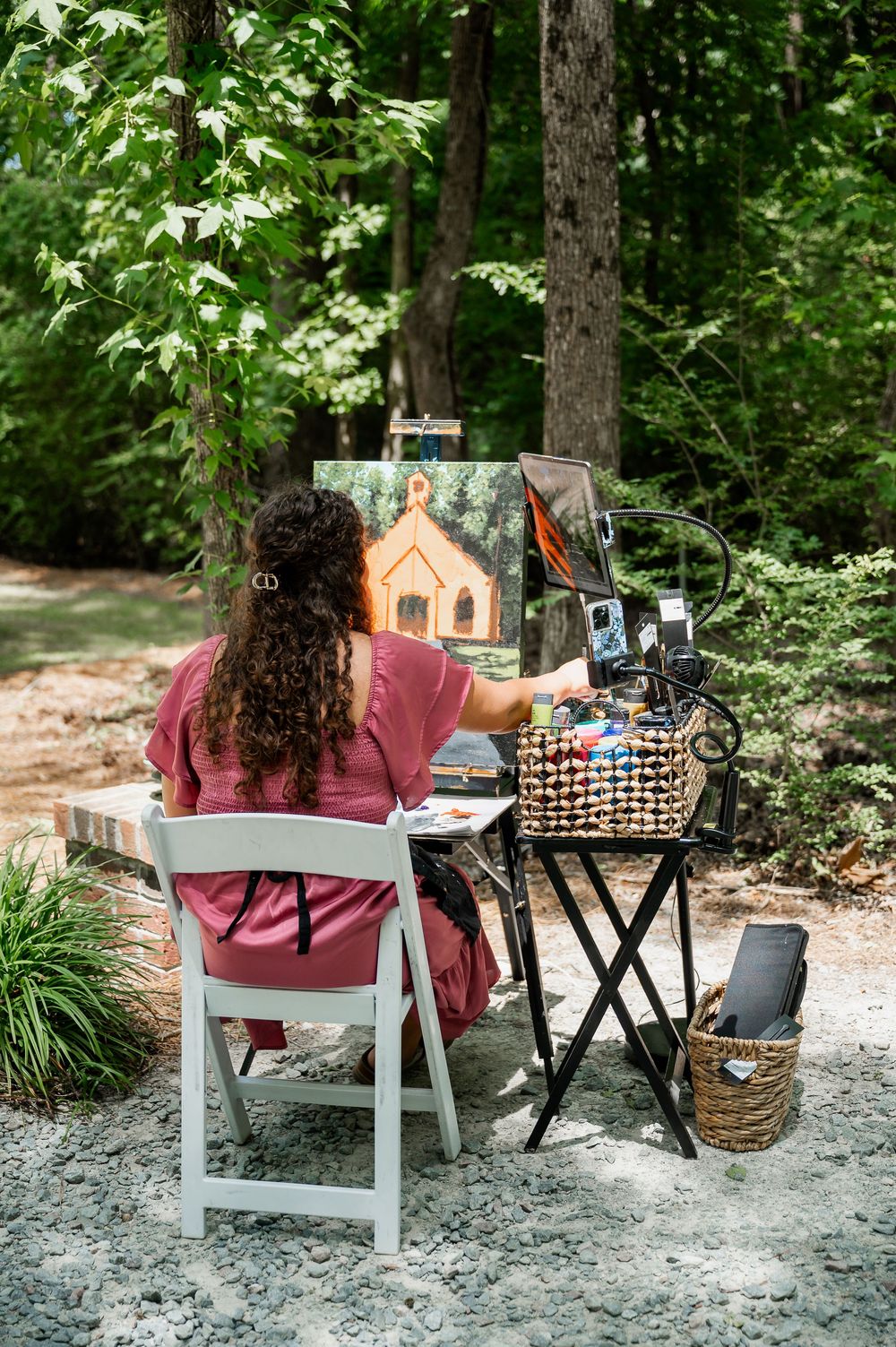 A rustic outdoor wedding setup with vintage decor and photography displays.