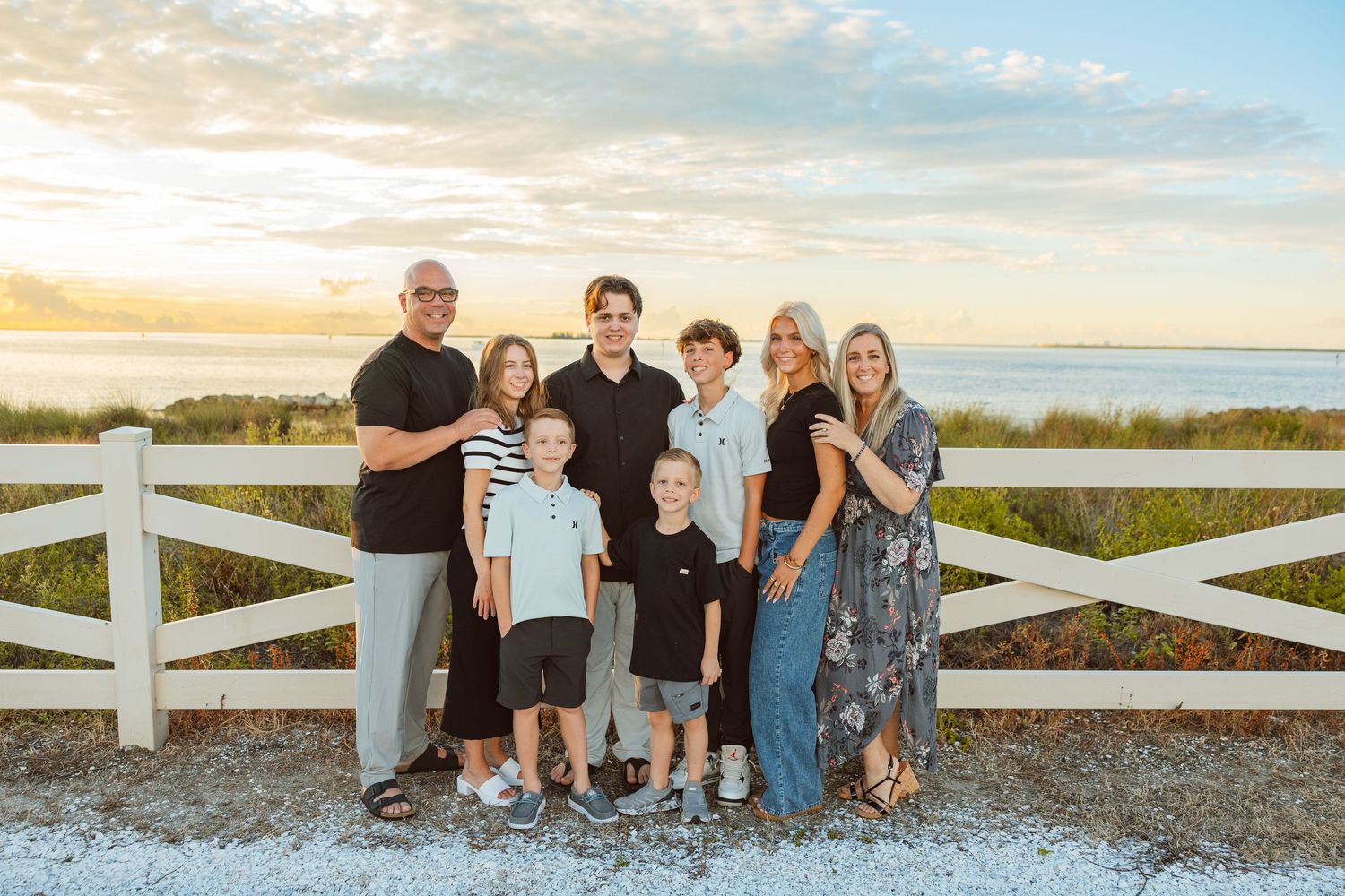 Large family posing together outdoors during a lifestyle family photography session.