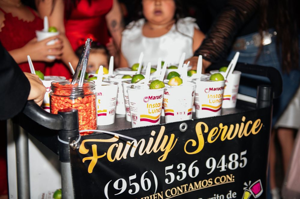 Colorful cocktails and drinks being served at a bar with neon signage and festive party atmosphere.