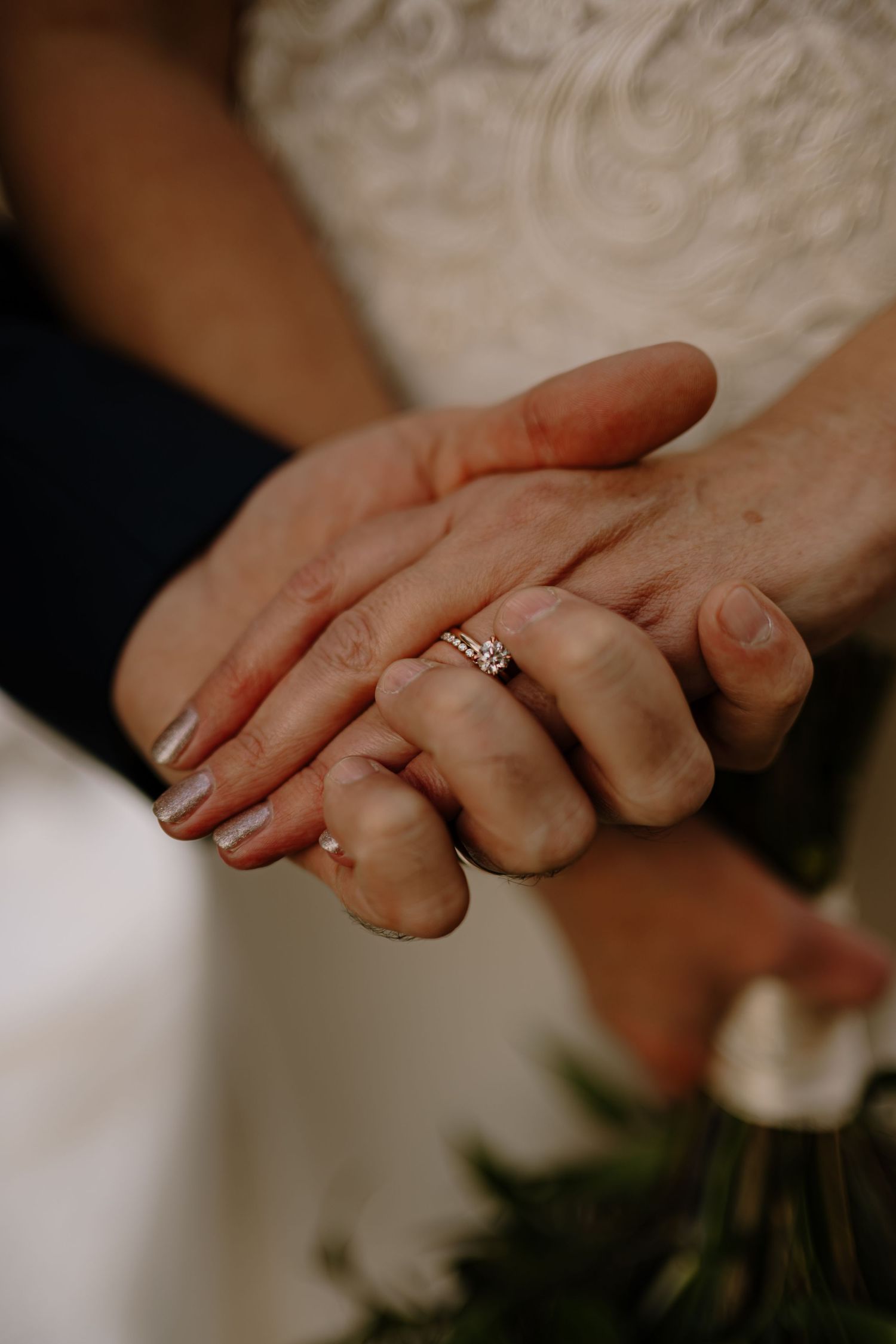 Close-up shots of intertwined hands with an engagement ring, showing a romantic moment between a couple.