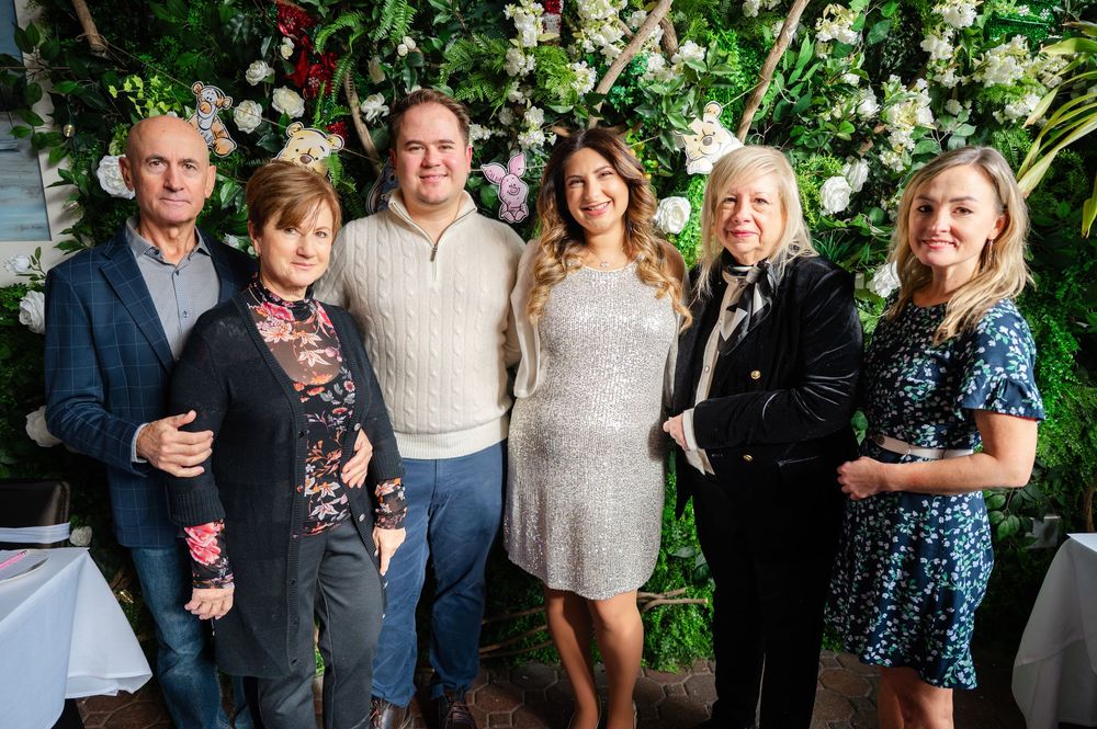 A group of people gathered together at what appears to be a social event or celebration in an outdoor setting.