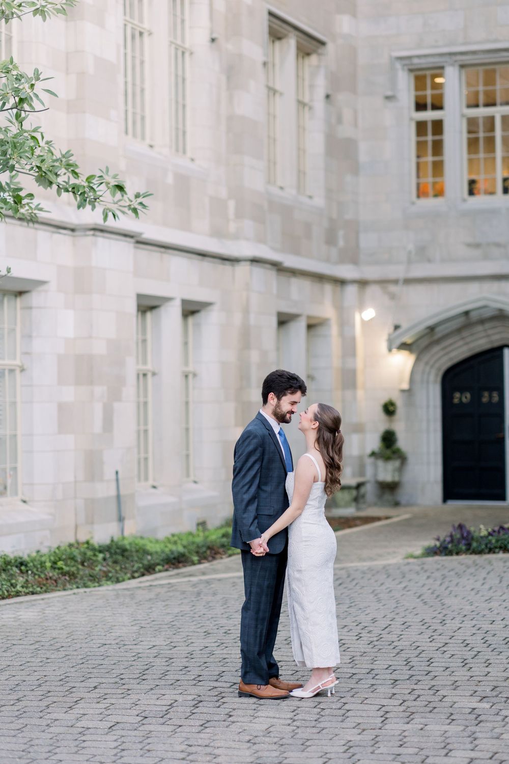 A romantic moment captured in a series of three photos on a cobblestone courtyard of a historic stone building.