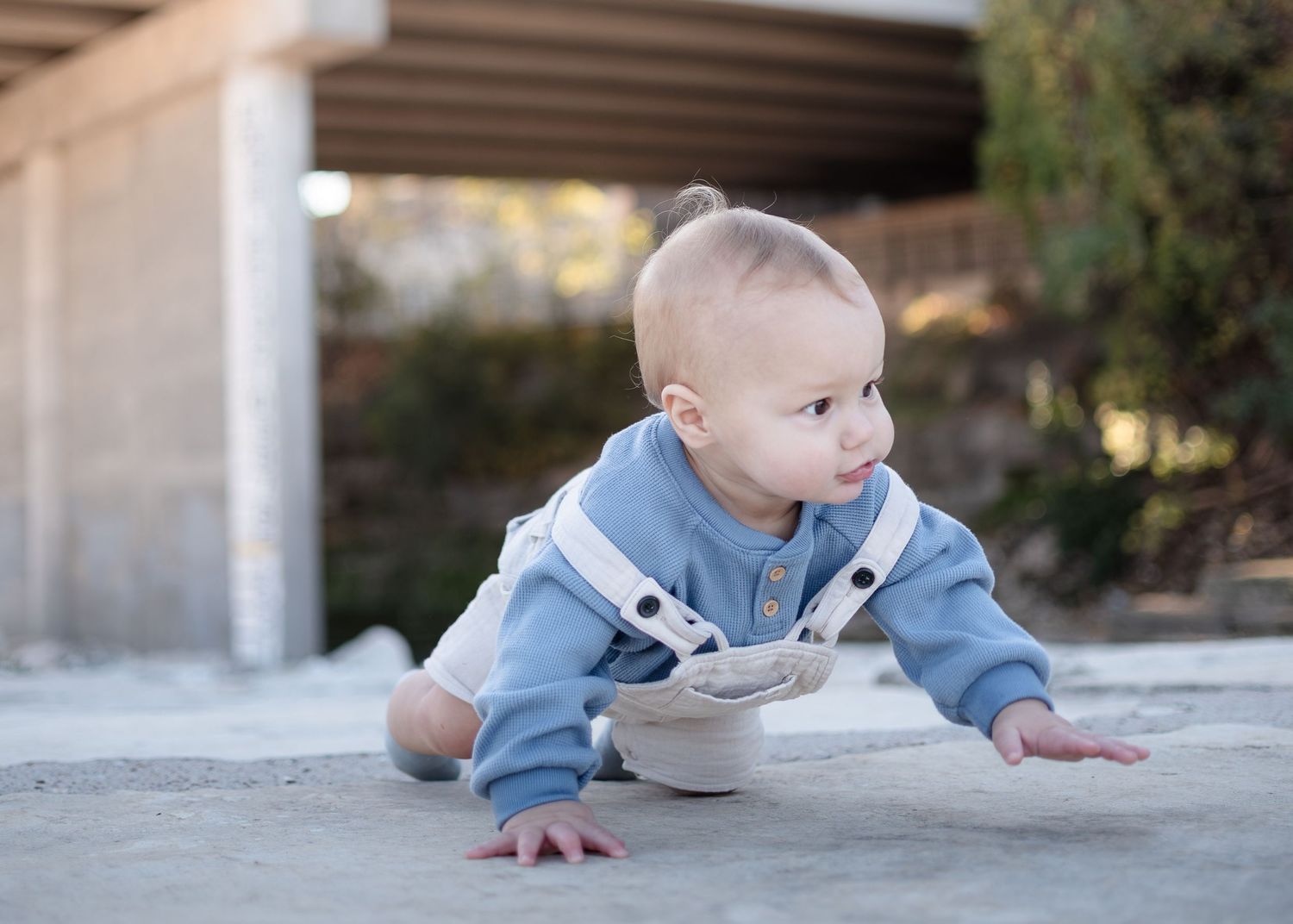 Baby crawling during outdoor family session at Nolan Creek in Belton Texas