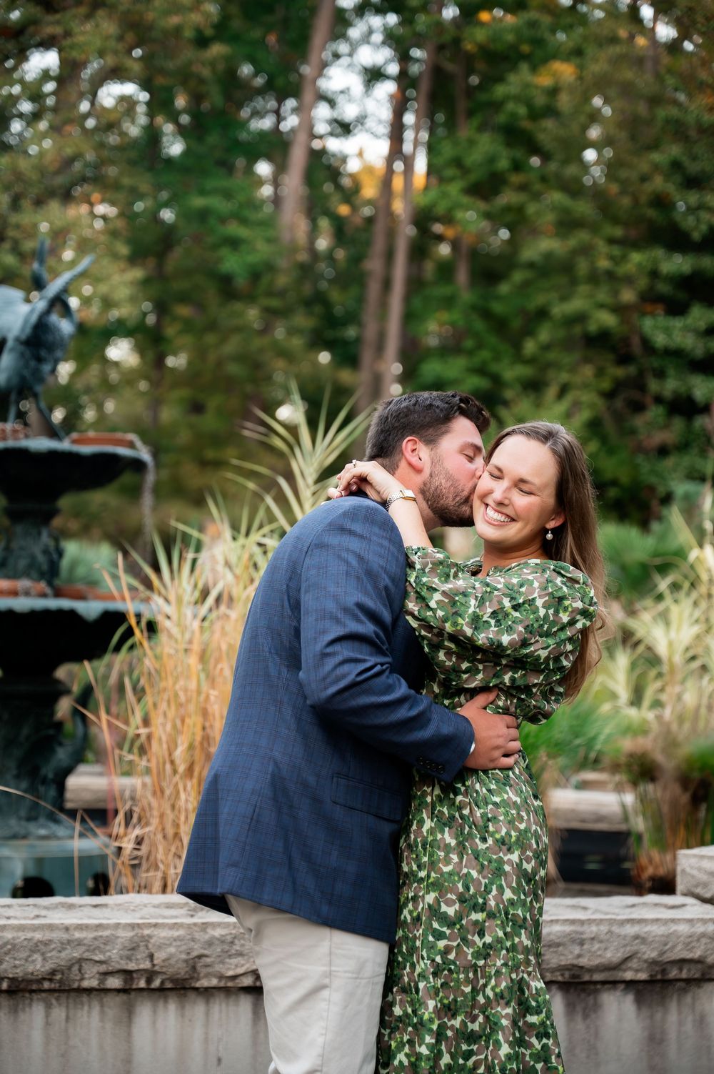 A couple embracing and dancing in a garden with stone walls and autumn scenery.
