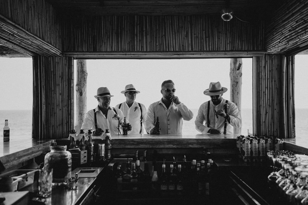 A collection of black and white photographs arranged in a filmstrip style showing wedding ceremony moments.