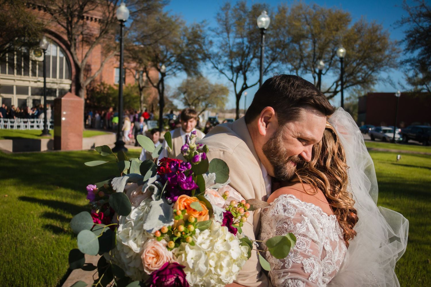 Larry and Misty smile during their wedding recessional at The Katy Depot in Denison, TX. Candid emotional moment by Wolfpack Wedding Co