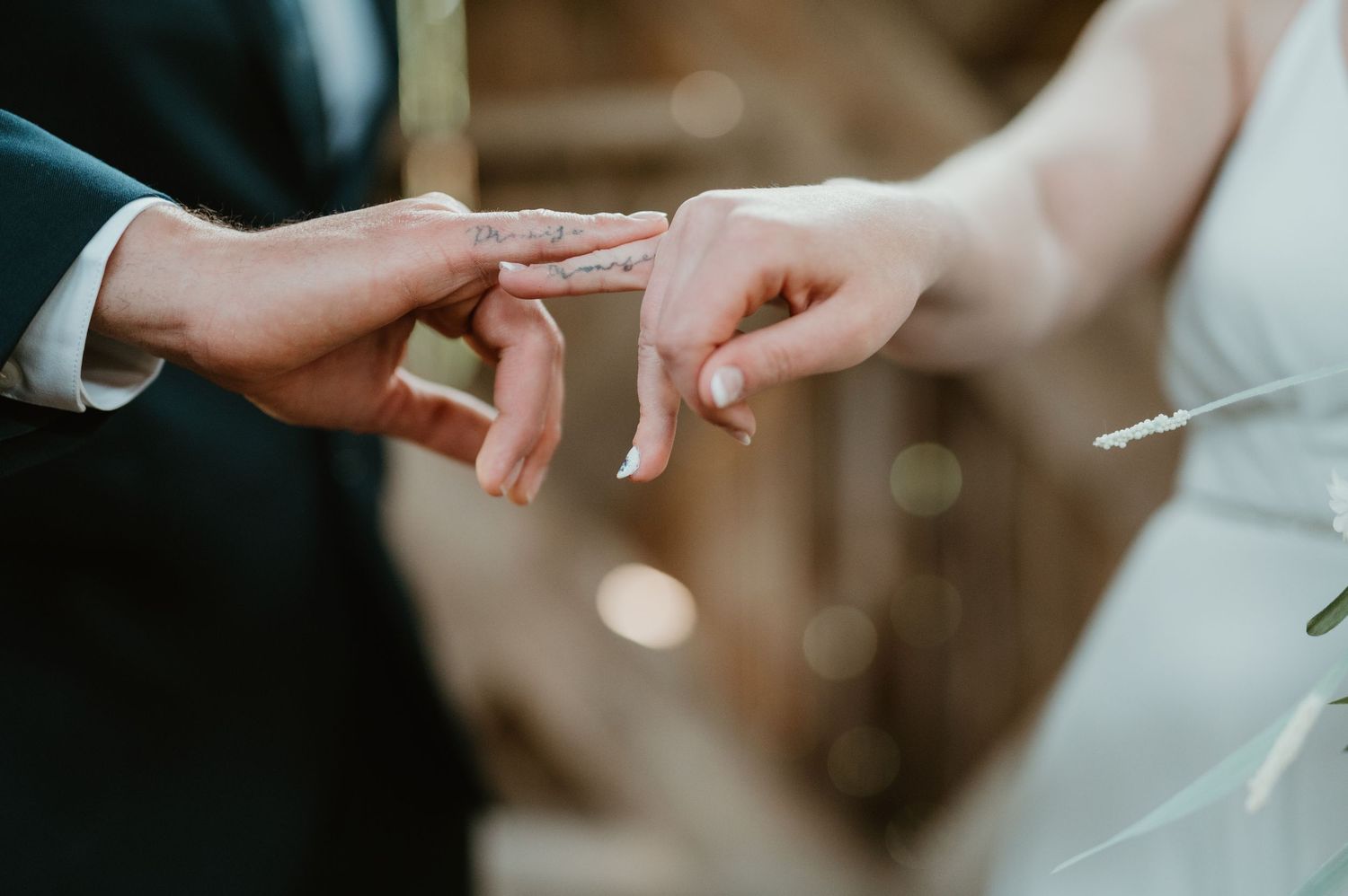 Close-up of a couple exchanging wedding rings during a marriage ceremony, symbolizing love and commitment.