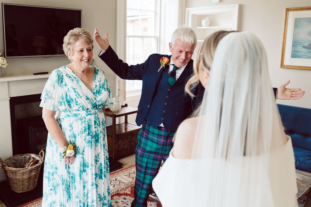 A series of emotional moments between family members during a wedding day celebration.