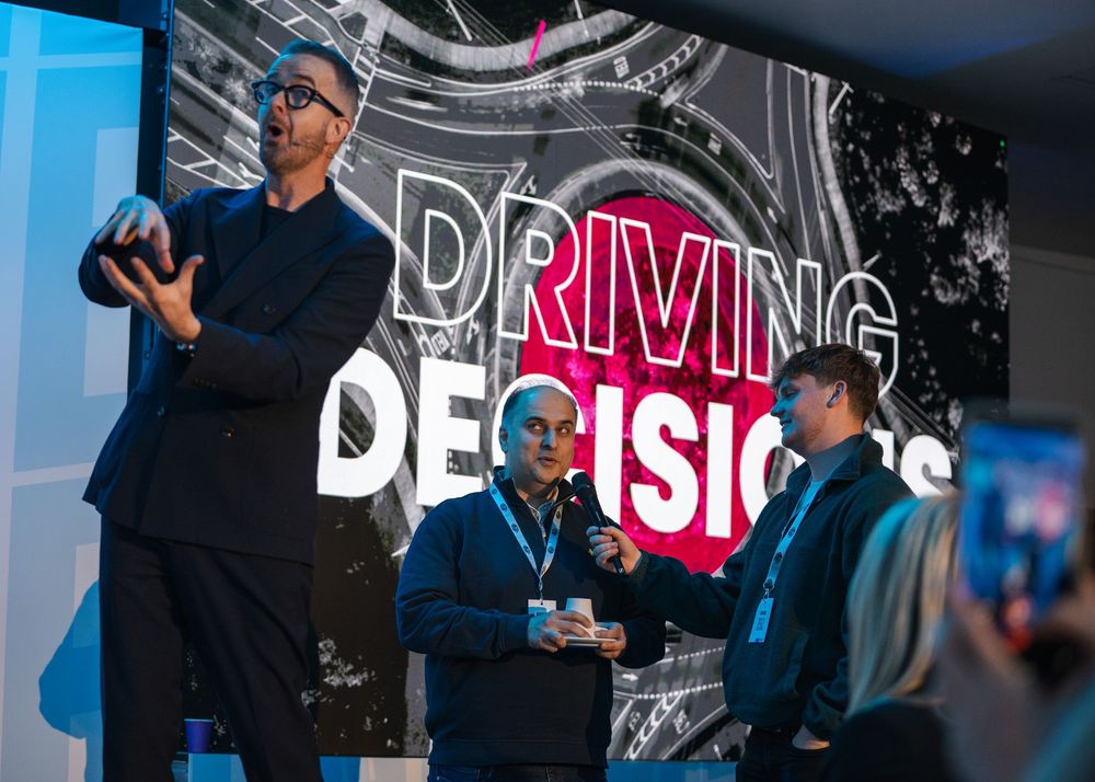 Modern conference stage design featuring illuminated text and graphics.