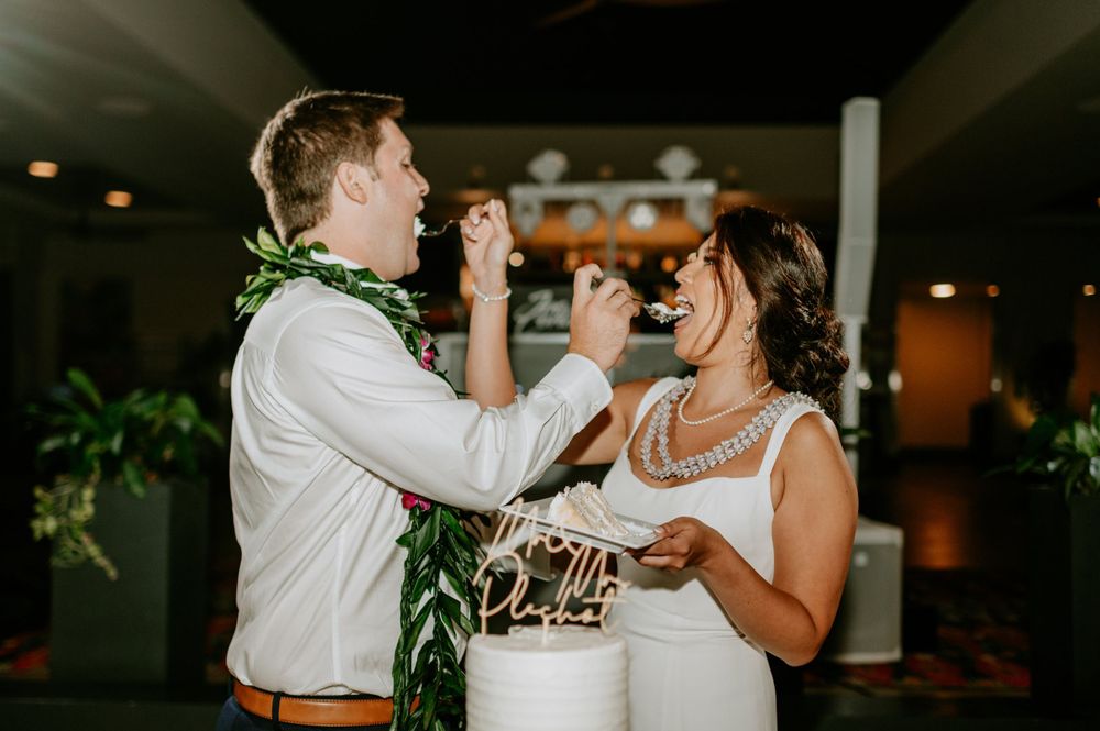 Close-up shot of newlyweds sharing their wedding cake during the reception.