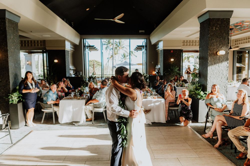 Wedding reception dance party with guests enjoying themselves in an indoor venue with natural lighting.