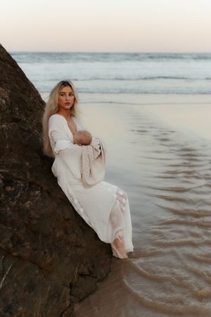 Ethereal seaside portraits with white flowing gowns and gentle waves creating a romantic coastal atmosphere.