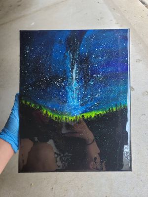 Acrylic painting depicts northern lights over dark forest with starry blue night sky.