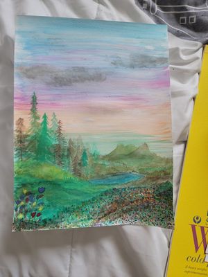 Watercolor landscape painting depicting a misty mountain forest scene with pastel sunset colors.