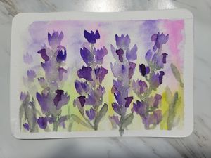 Loose watercolor painting of purple iris flowers in a meadow with soft green foliage.