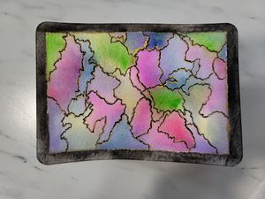 Abstract watercolor painting with puzzle-like sections in soft pink, green and purple tones.