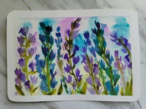 Vibrant watercolor painting of purple and blue wildflowers with loose, expressive brushstrokes.