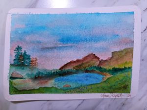 Watercolor landscape depicting a serene lake surrounded by mountains and evergreen trees.