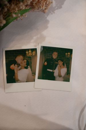 Vintage polaroid photos displayed on a white surface showing wedding moments.