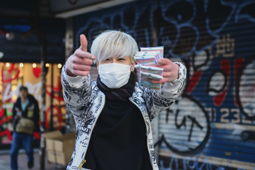 Urban street scene with graffiti-covered walls and pedestrians in winter clothing.