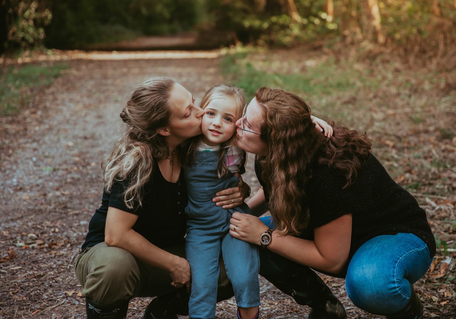 A joyful family moment captured During a family photoshoot in Bexley during autumn as they share hugs and laughter together.