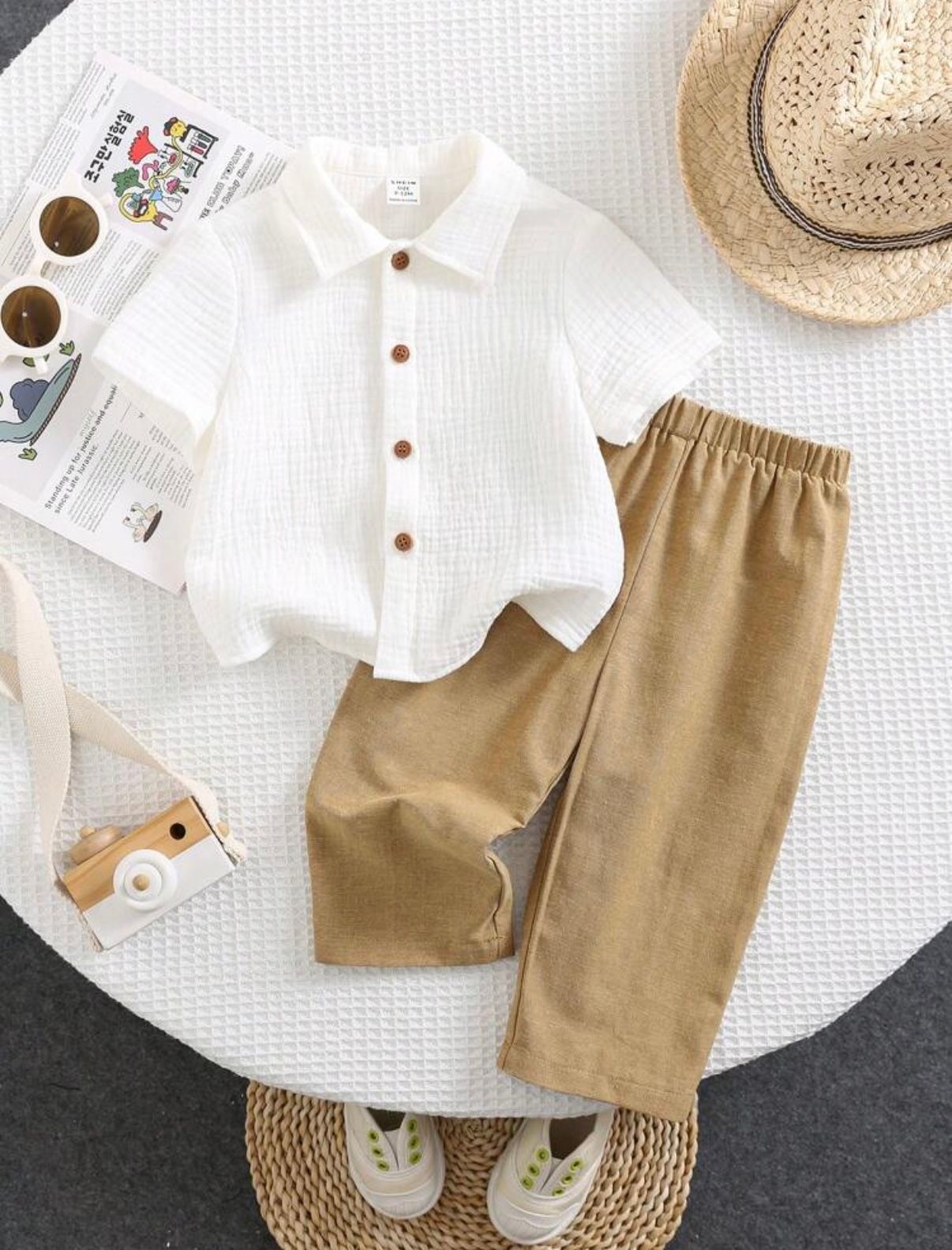 White button-down shirt and khaki pants set for toddlers with straw hat and shoes.