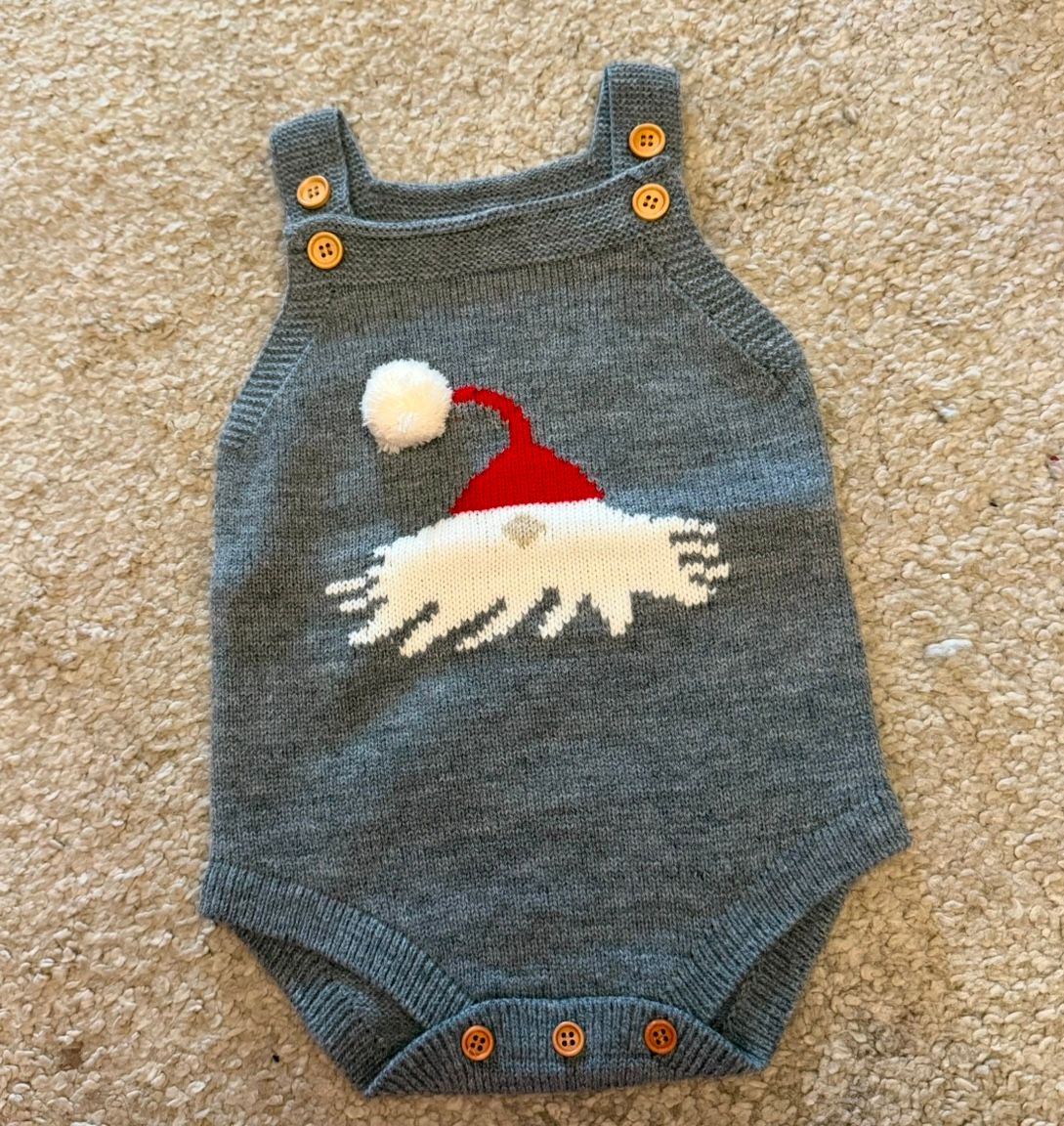Gray baby romper with santa design on front.