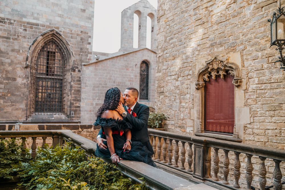 Couple standing in front of rustic wooden doors