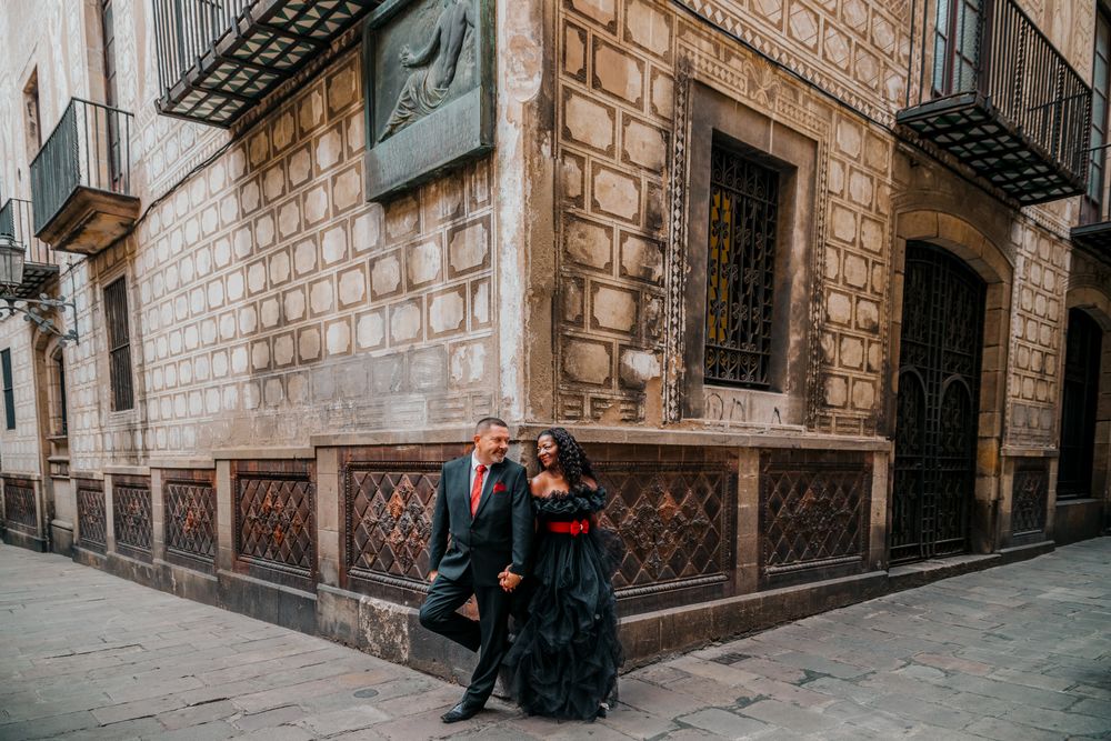 Couple walking past wrought-iron balconies and ivy