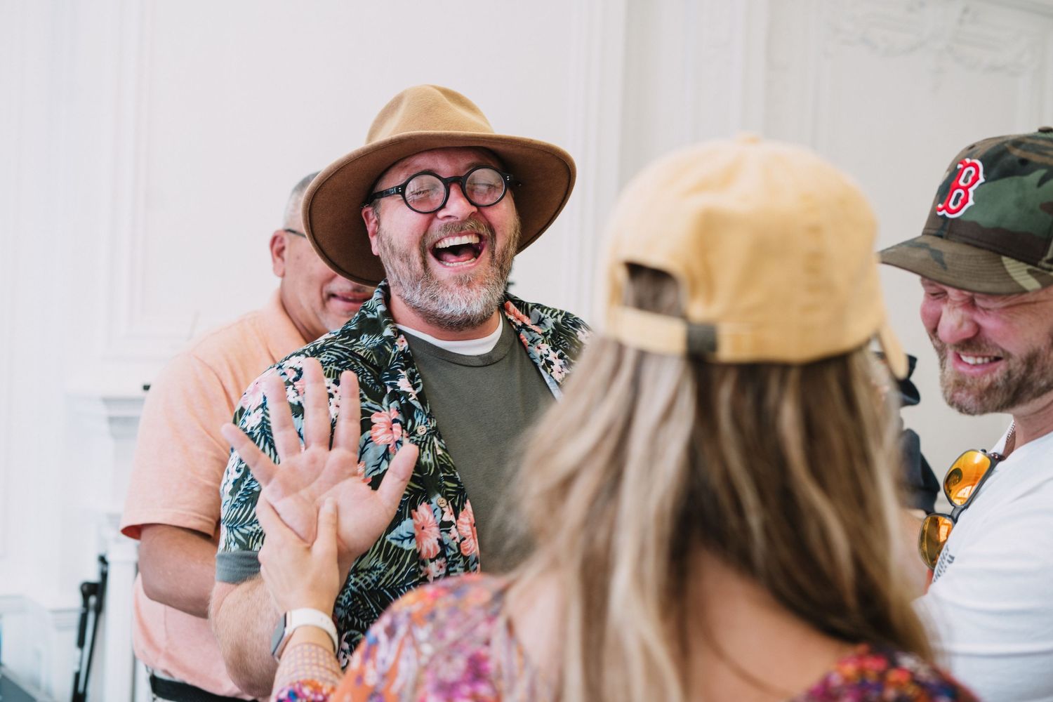 Image of people man smiling and laughing at a Christian event with the ekklesia in London UK. Faith based photographer London Jenny Catlow