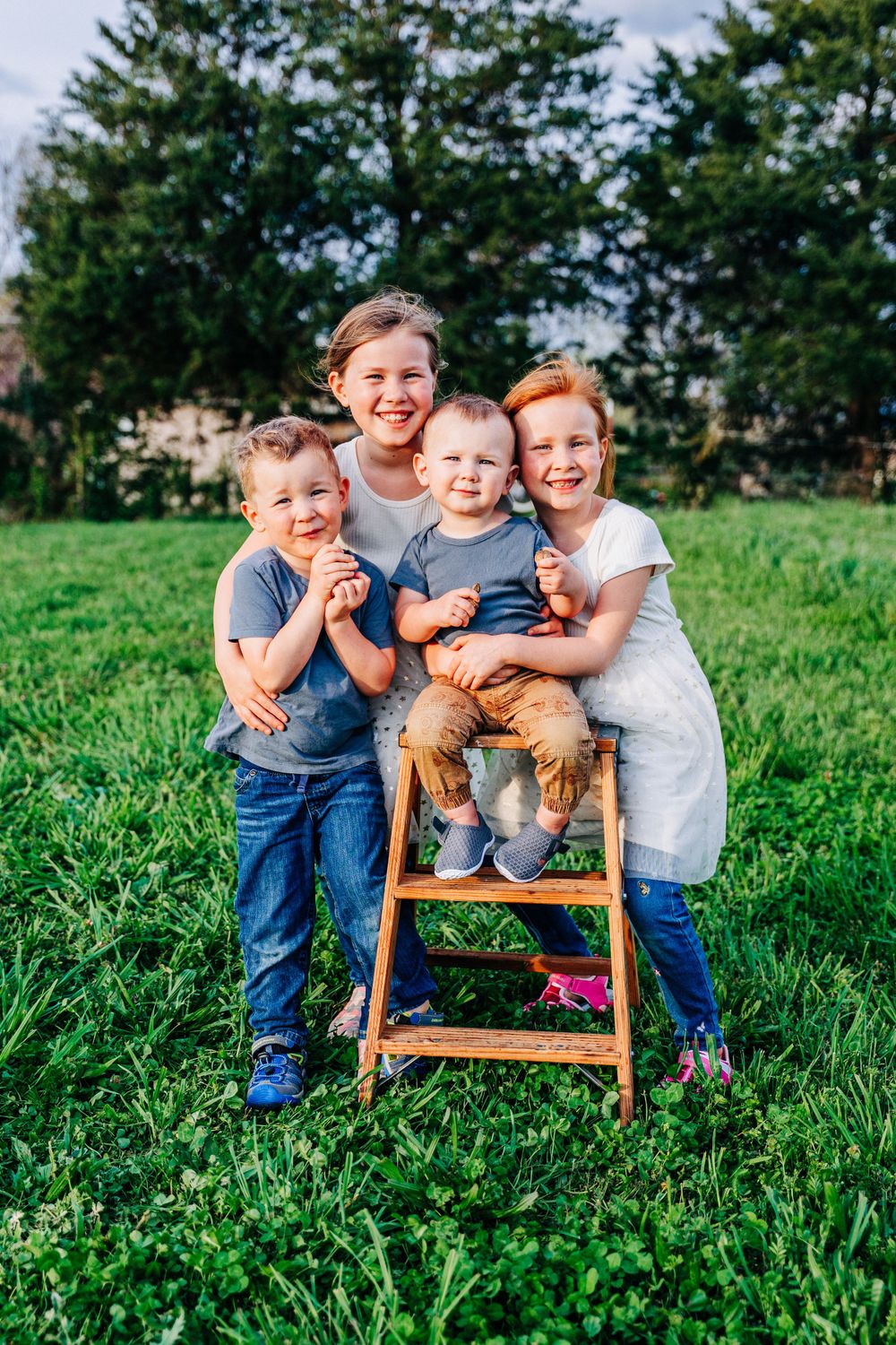 Photo of 4 siblings taken on a farm in Dandridge by East Tennessee lifestyle family portrait photographer.