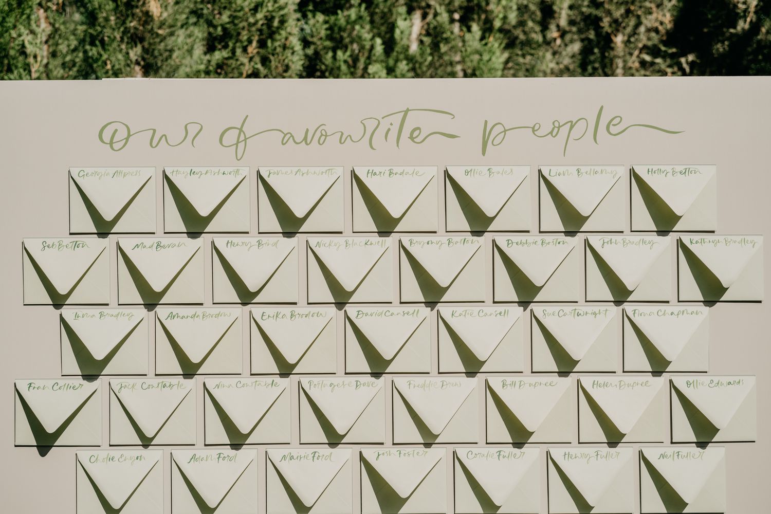 Wedding seating chart with geometric triangle pattern design.