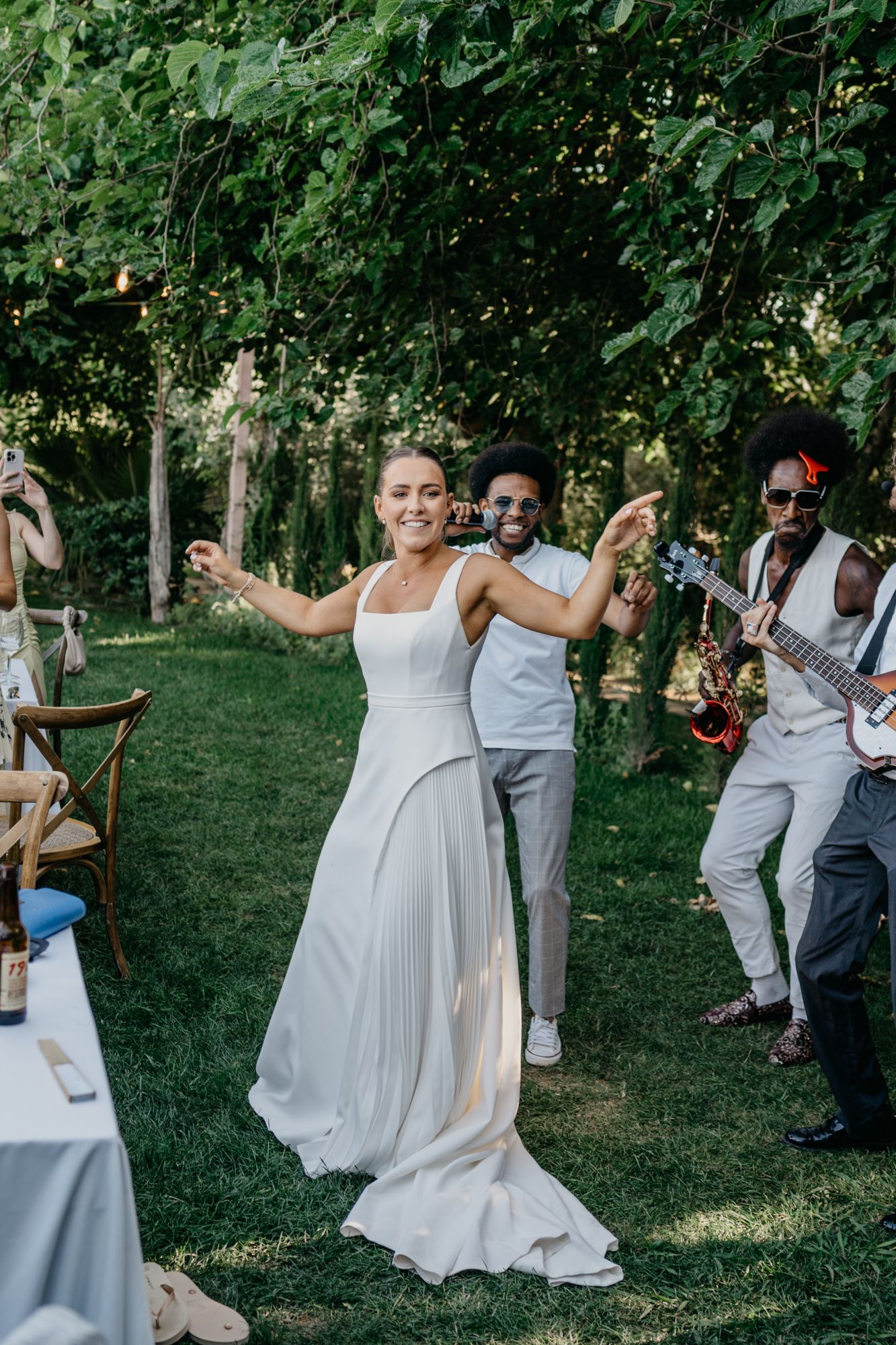 Dancing and celebration at an outdoor wedding reception with live music.