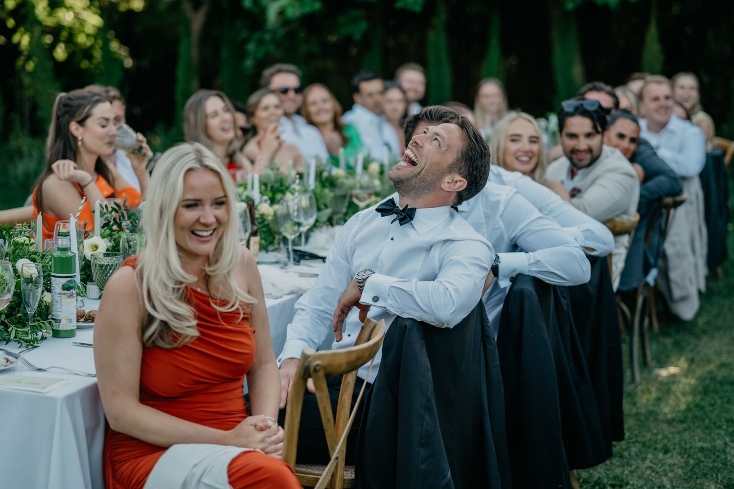 Wedding guests enjoying themselves during outdoor dinner reception.