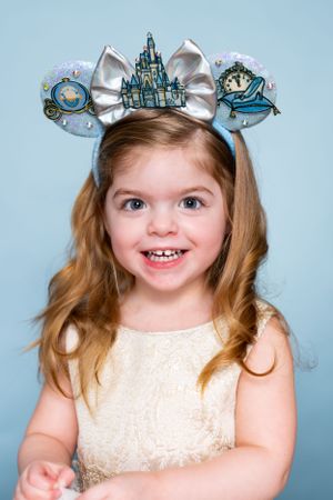 Cinderella castle themed Mickey ears with silver bow and clock details modeling for The Minnie Castle.