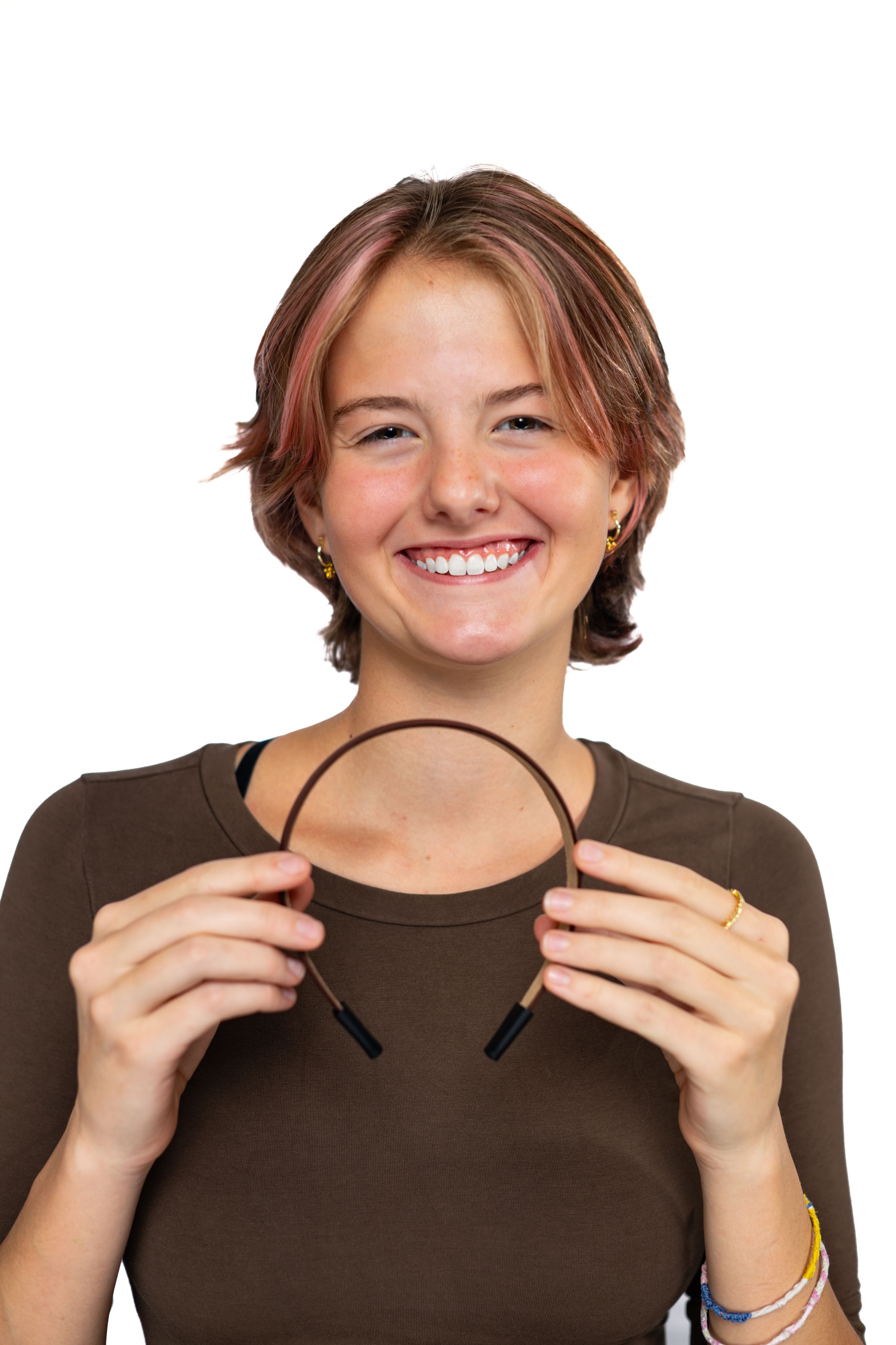 Portrait showing person holding simple black headbandmodeling for Hug A Band.