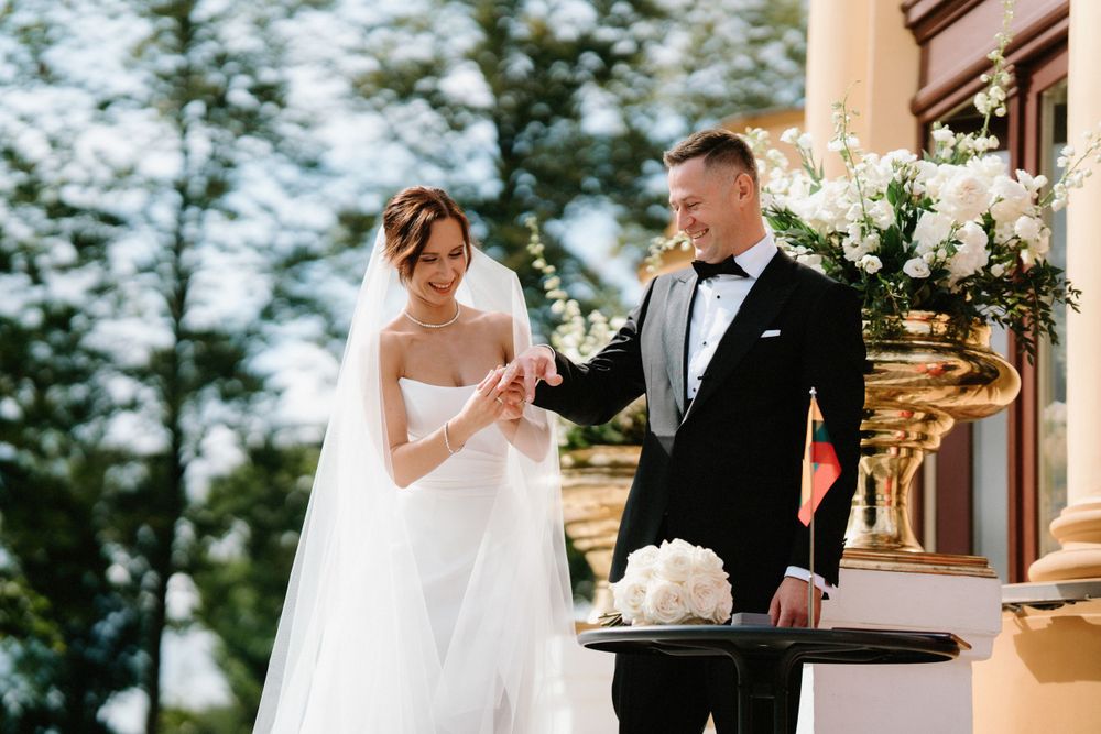 Elegant wedding ceremony taking place on stone steps of historic building.