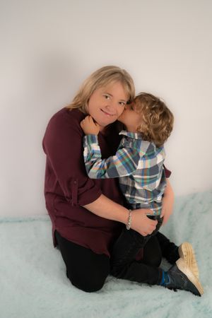 Sweet moment captured between adult and child during indoor photo session.
