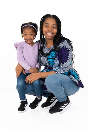 Portrait of two people in casual attire with one wearing a colorful patterned top.
