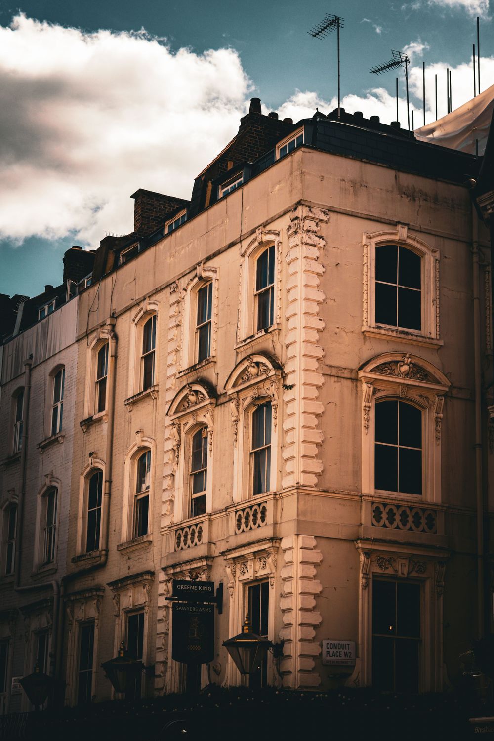 A vintage Victorian-style building with ornate architectural details and arched windows.