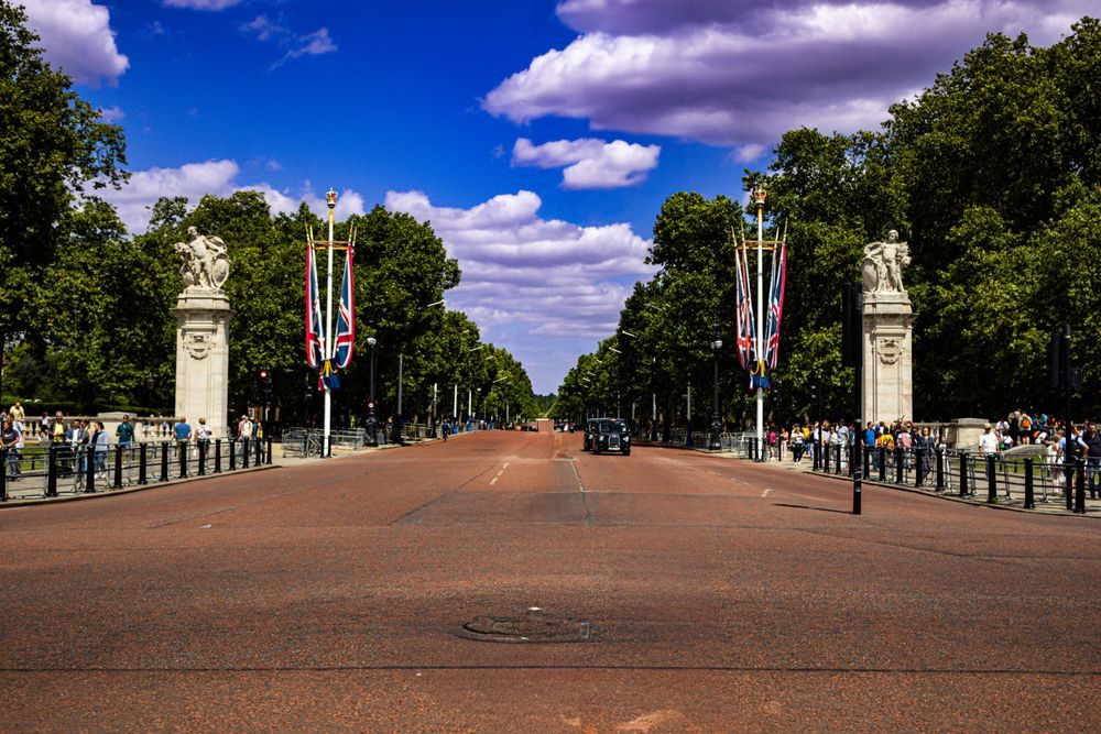 The Mall in London with Union Jack flags and trees lining the ceremonial route.