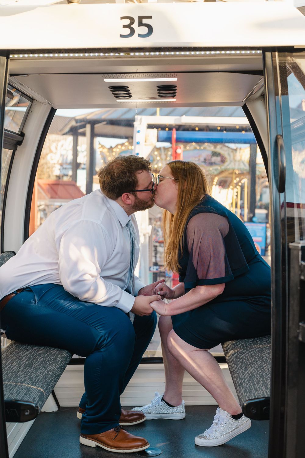 A romantic moment captured inside cable car number 35 with two people sharing an affectionate kiss.